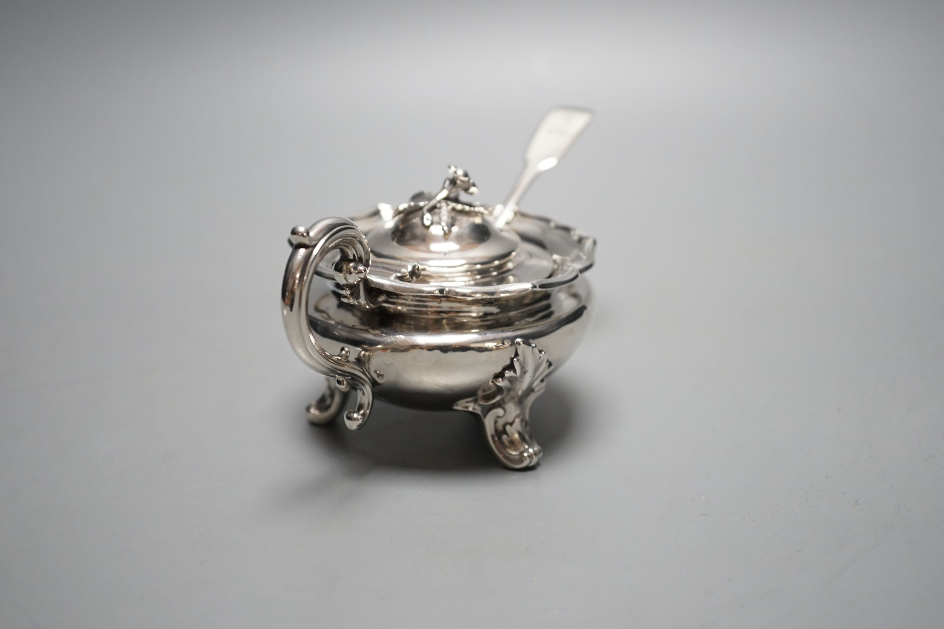 A late William IV silver circular mustard pot, with blue glass liner, The Barnards, London, 1837, with earlier associated fiddle pattern mustard spoon.